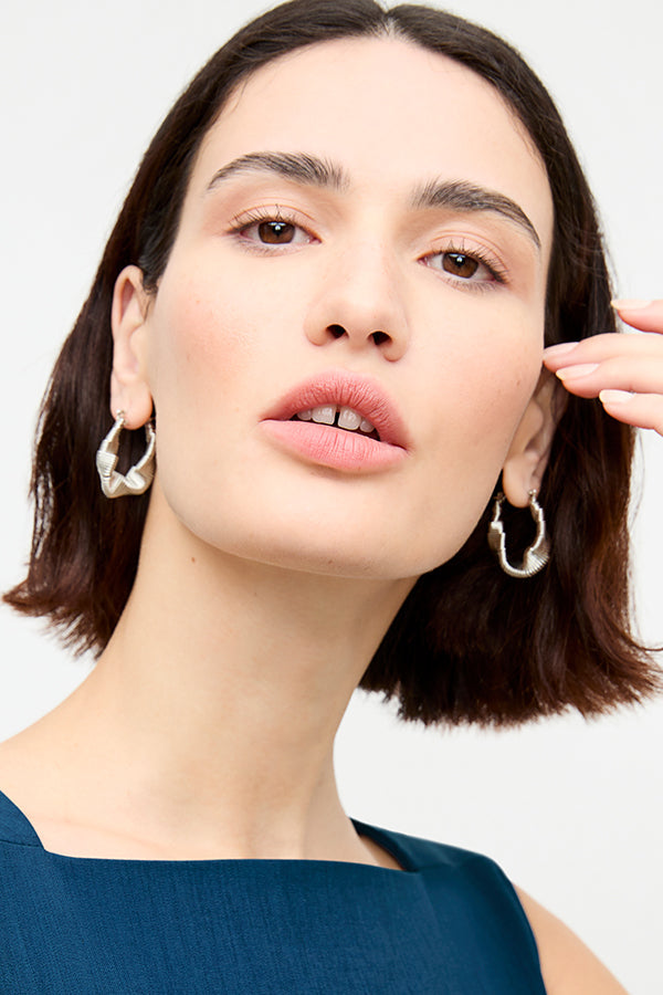 front image of a woman wearing the amy earrings in silver | Exclude | Grid Hover
