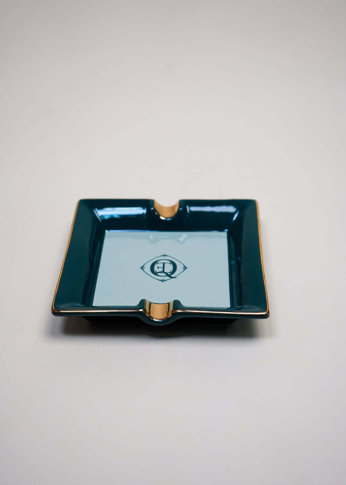 Monogram gold trim ceramic catchall tray with green color and centered logo, perfect for jewelry or as an ashtray.