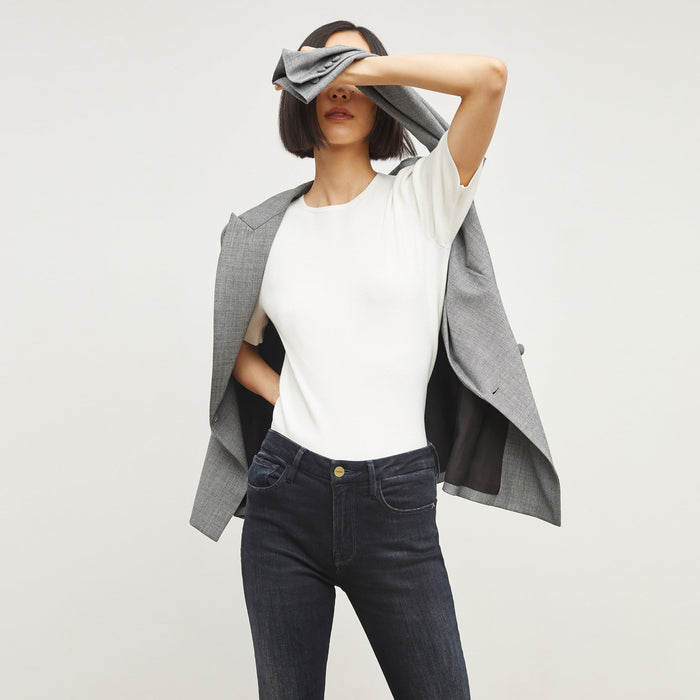 Front image of a woman standing wearing the choe top in ivory | Exclude