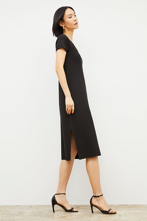 Side image of a woman wearing the Danica Dress - Geo Micro Knit in Black | Exclude