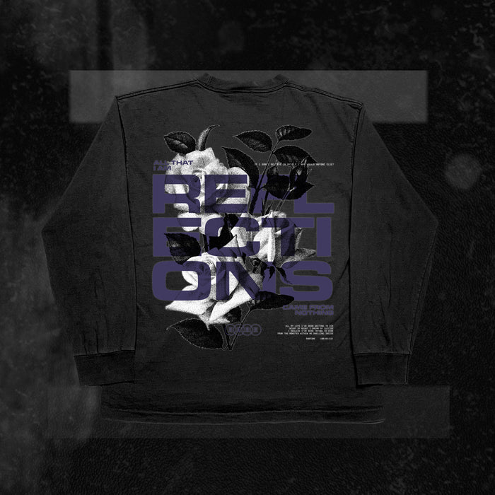 A black Reflections long-sleeve shirt features a white rose with green leaves on the back. Bold purple text reading RELATIONS overlaps the flower, with smaller white text above and below. Made from 100% cotton for comfort.