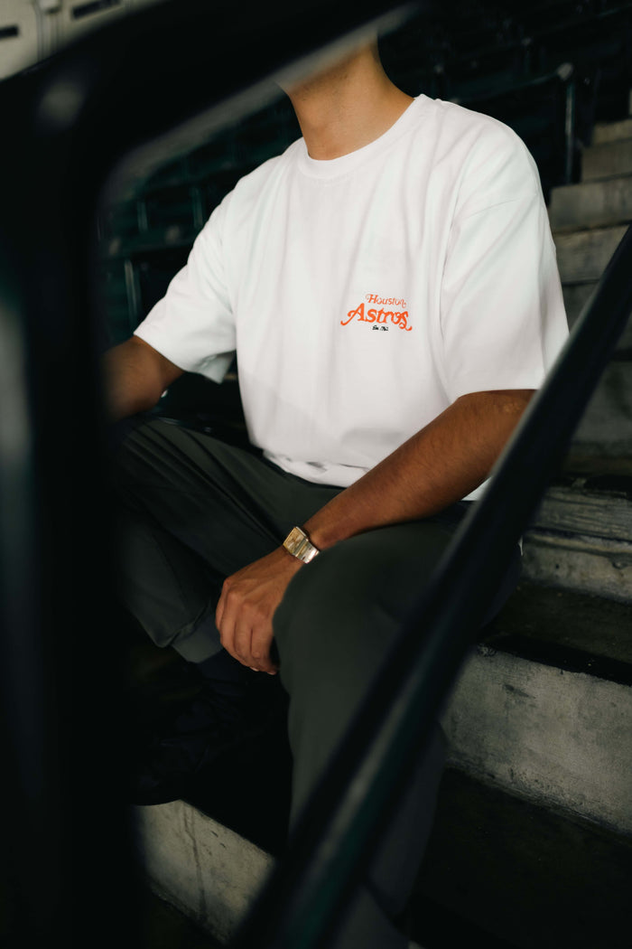 Person wearing a white Home collaboration t-shirt featuring Éclectique x Do Different design in Houston.