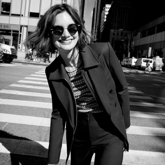 Front image of a woman wearing the kati jacket in forest | Lead