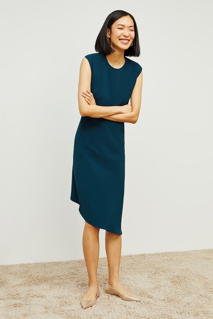 Front image of a woman standing wearing the Lara Dress in Rainforest | Grid | Exclude