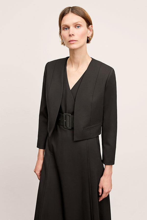 Front image of a woman standing wearing the Neale jacket in black | Exclude | Grid