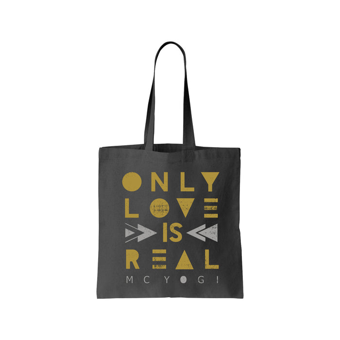 A black MC YOGI tote bag with gold geometric text reading “ONLY LOVE IS REAL” and MC YOGI in small white letters at the bottom.