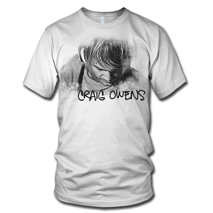 This white t-shirt by Craig Owens features a black-and-white illustration of a person with head bowed, hair covering their face, and CRAIG OWENS in bold, handwritten-style letters above the artwork.