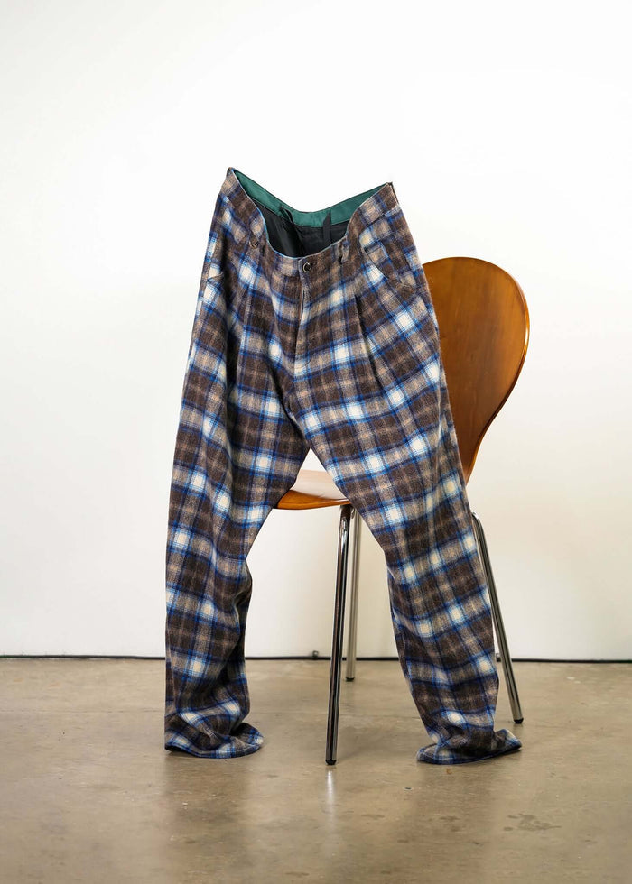 Éclectique Mercer Plaid Pleated Trousers draped on chair front view