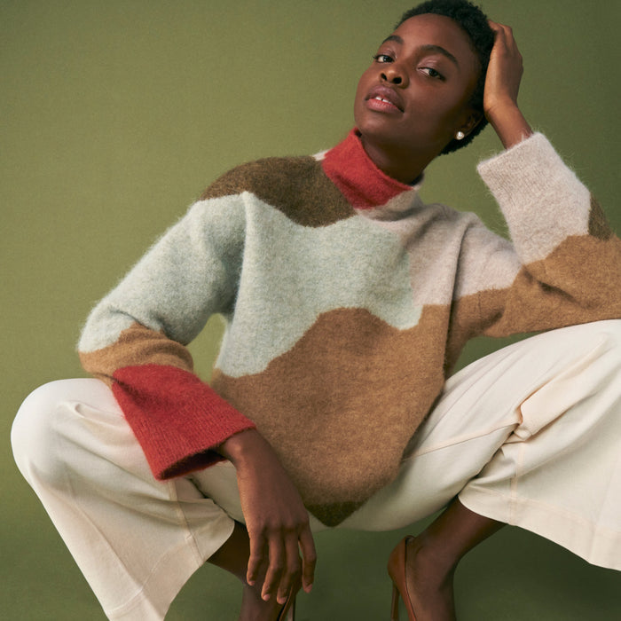 front image of a woman wearing the rajni sweater in multi