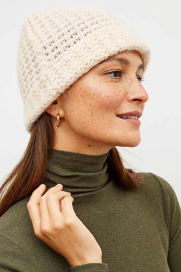 Image of a woman wearing the beanie in ivory | Exclude