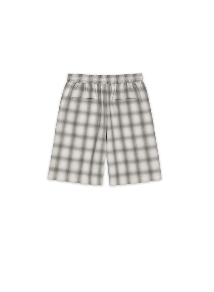 Tailored monotone plaid shorts featuring a refined silhouette and front pleats, made from 100% cotton.