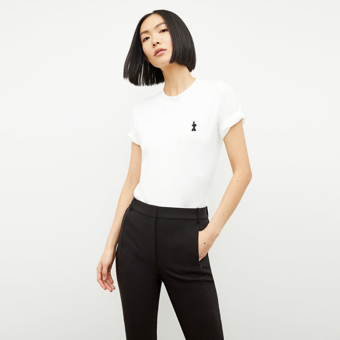 front image of a woman wearing the leslie t-shirt embroidered in white | Lead