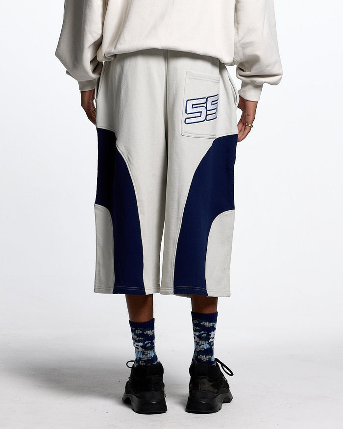 55 SWEAT SHORTS LIGHT GREY - light grey colorblock sweat shorts, back view on male model - Cold Culture #man