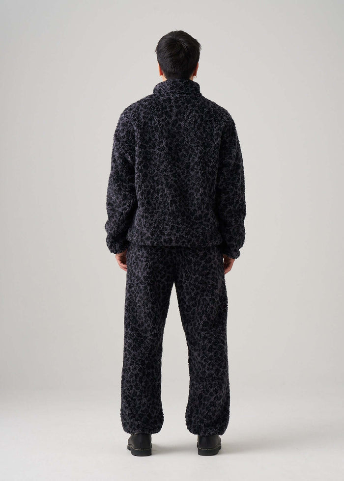 Back view of Éclectique black leopard fleece jacket worn by model