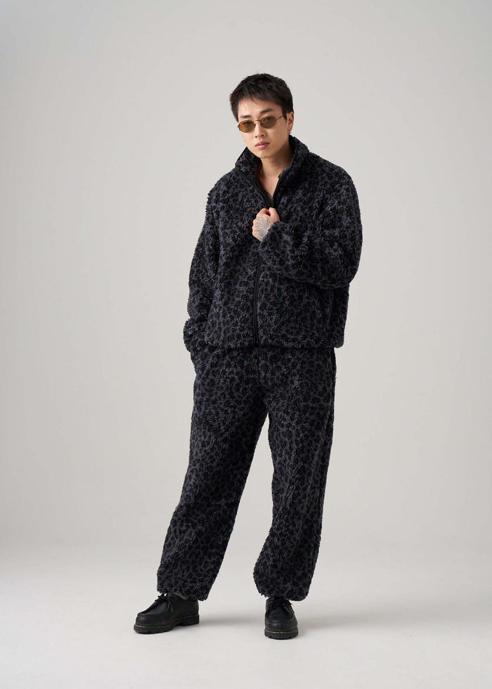 Model wearing Éclectique black leopard fleece jacket in studio