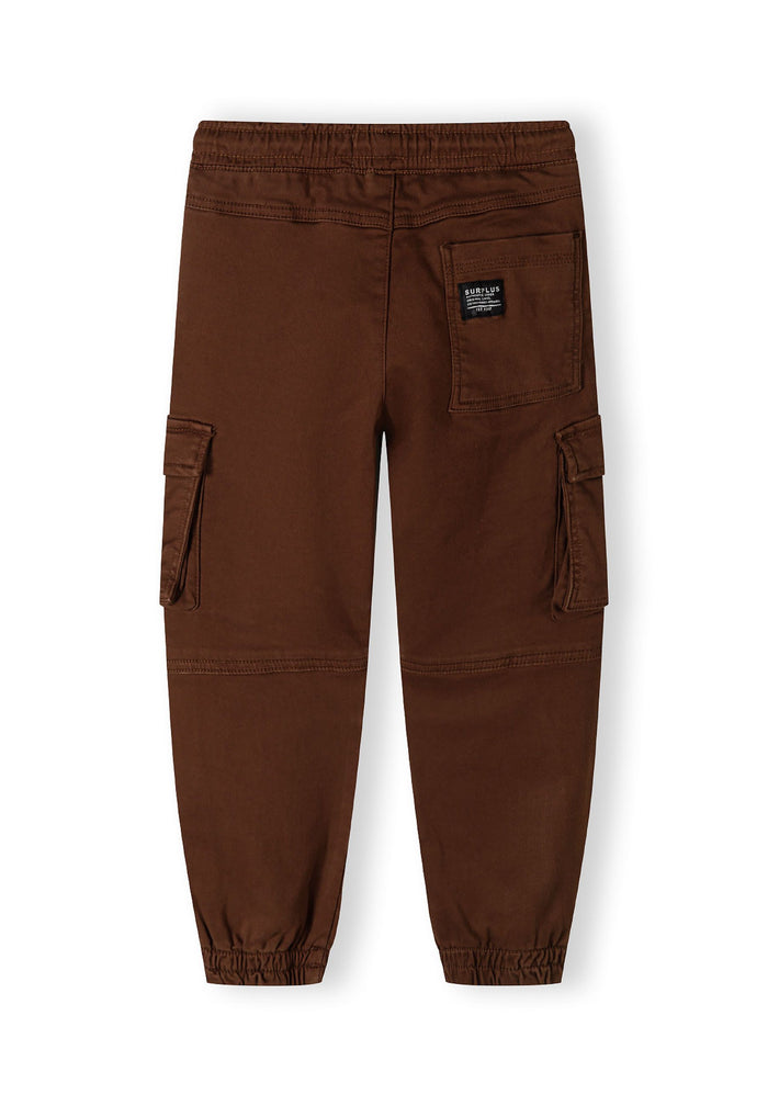 Boys cargo trousers in brown, back view with cargo pockets and ribbed ankle cuffs.