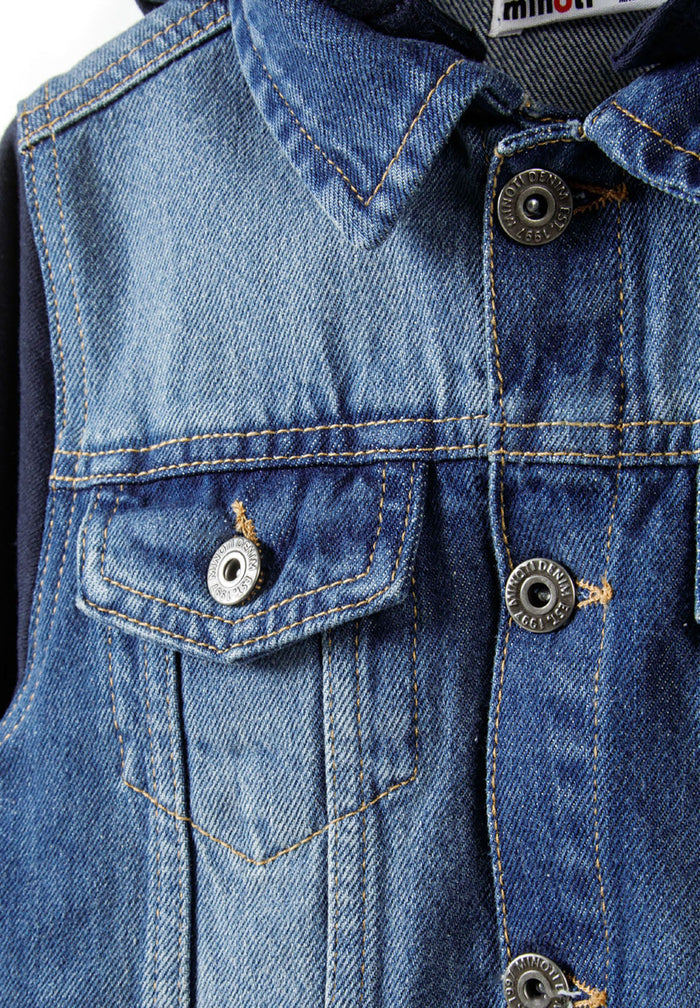 Detail of boys denim jacket with button-up front and chest flap pocket.