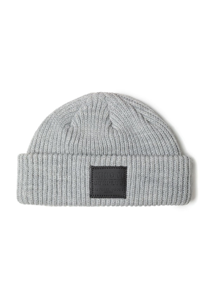 Detail of a grey knitted fisherman hat with a ribbed brim and logo badge.