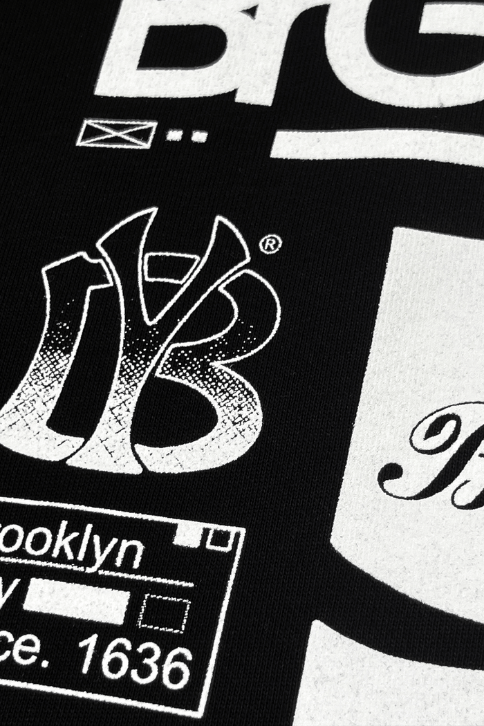 Close-up of printed artwork on Brooklyn graphic t-shirt featuring bold black and white designs.