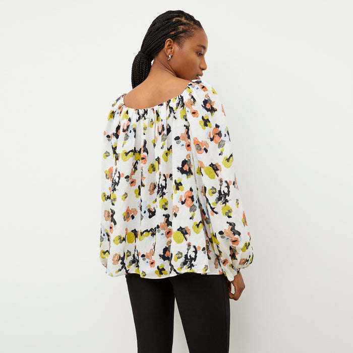Back image of a woman wearing the Camilla top in meadow print linen