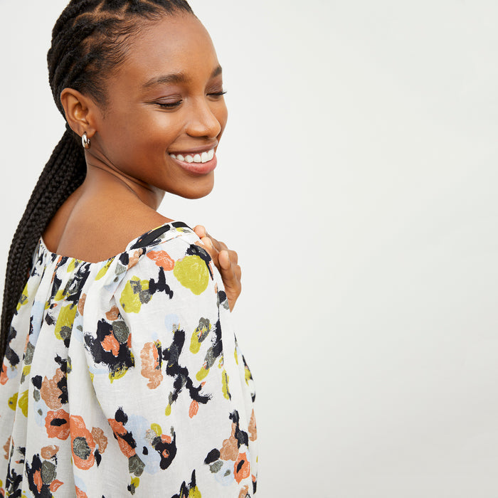 Front image of a woman wearing the Camilla top in meadow print linen