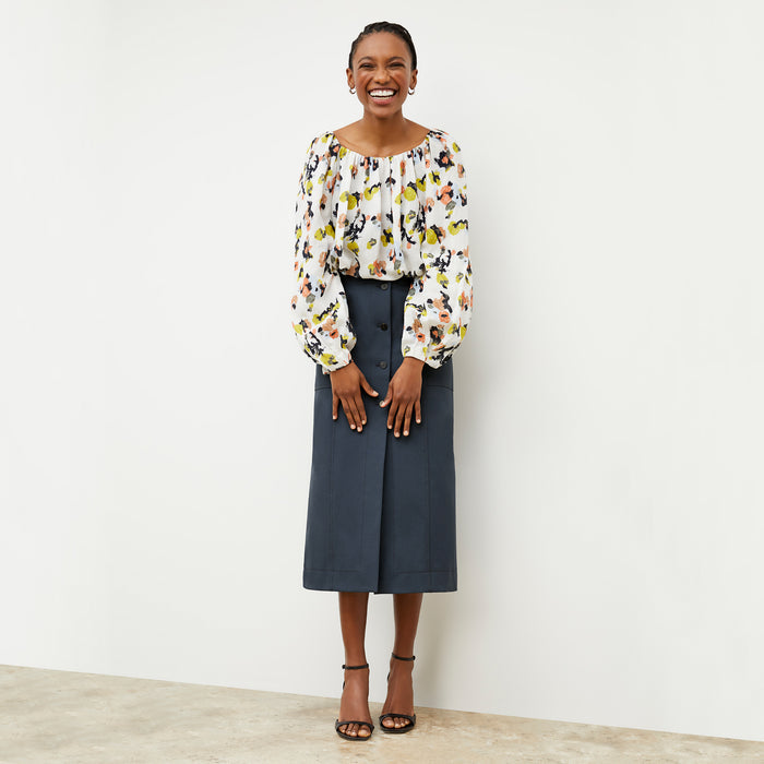 Front image of a woman wearing the Camilla top in meadow print linen