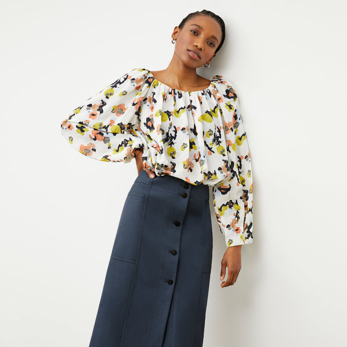 Front image of a woman wearing the Camilla top in meadow print linen