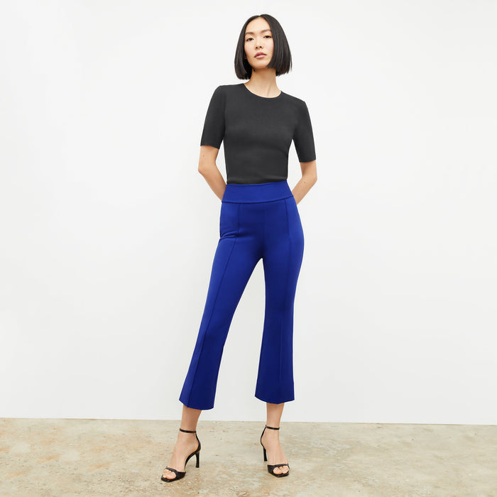 Front image of a woman standing wearing the Choe Top in Black