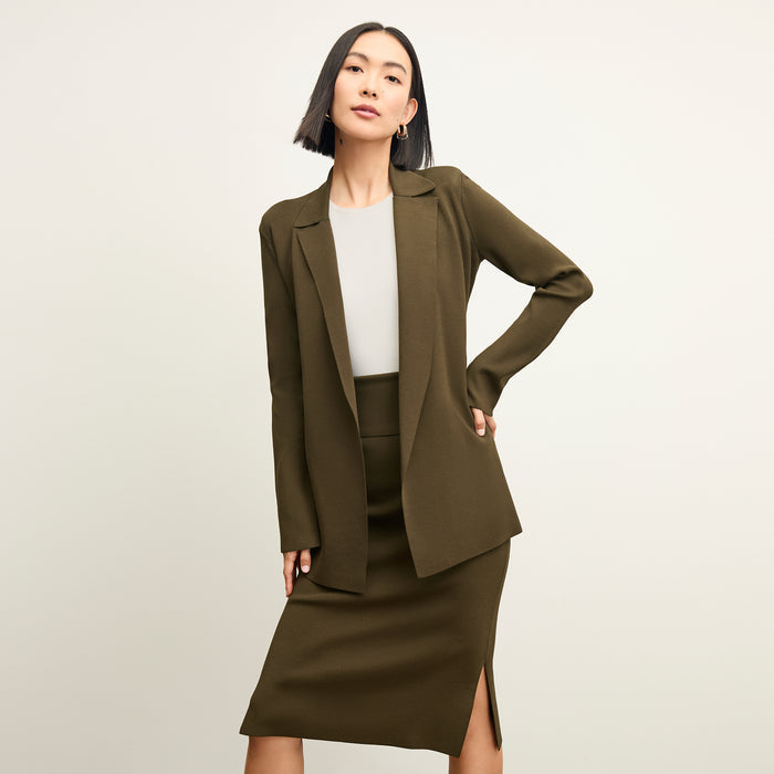 Front image of a woman standing wearing the choe top in ivory | Exclude