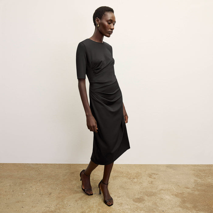 front image of a woman wearing the ciela dress in black