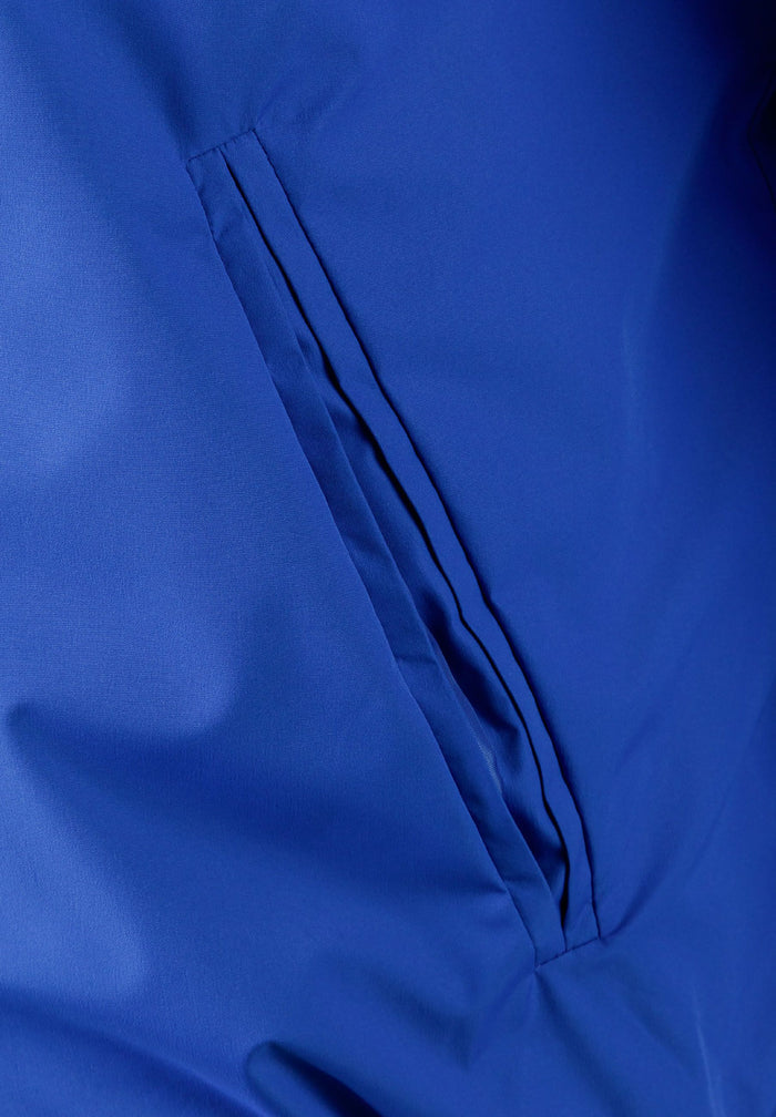 Detail of a cobalt blue men's baseball jacket showing a zippered pocket.