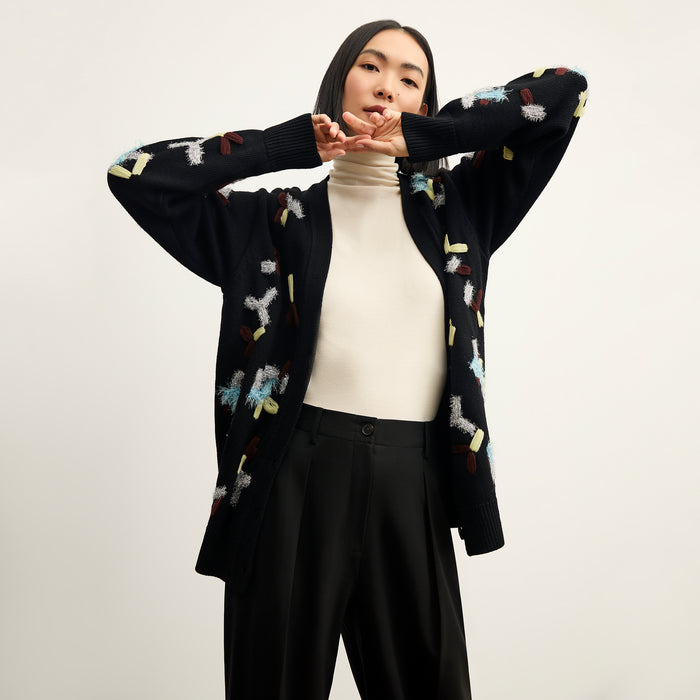 front image of a woman wearing the cookie cardigan in confetti | Lead