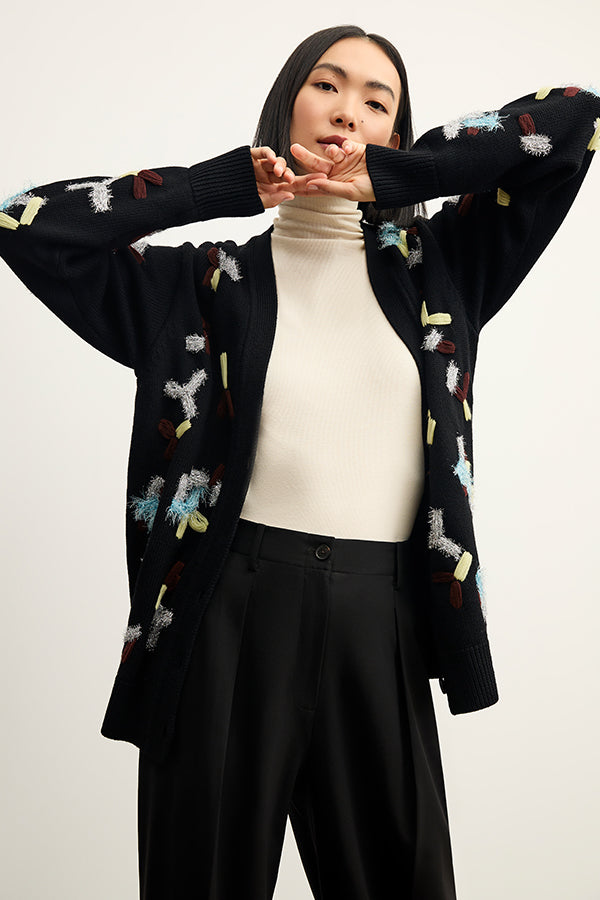 front image of a woman wearing the cookie cardigan in confetti | Exclude | Grid