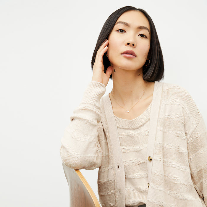 front image of a woman wearing the cookie cardigan in moonbeam
