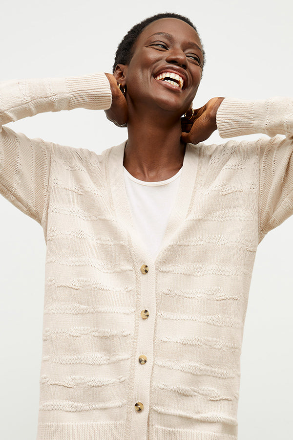front image of a woman wearing the cookie cardigan in moonbeam | Exclude | Grid Hover