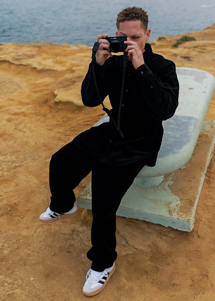 Person wearing a Corduroy Button-up Shirt posing for a photo by the water.