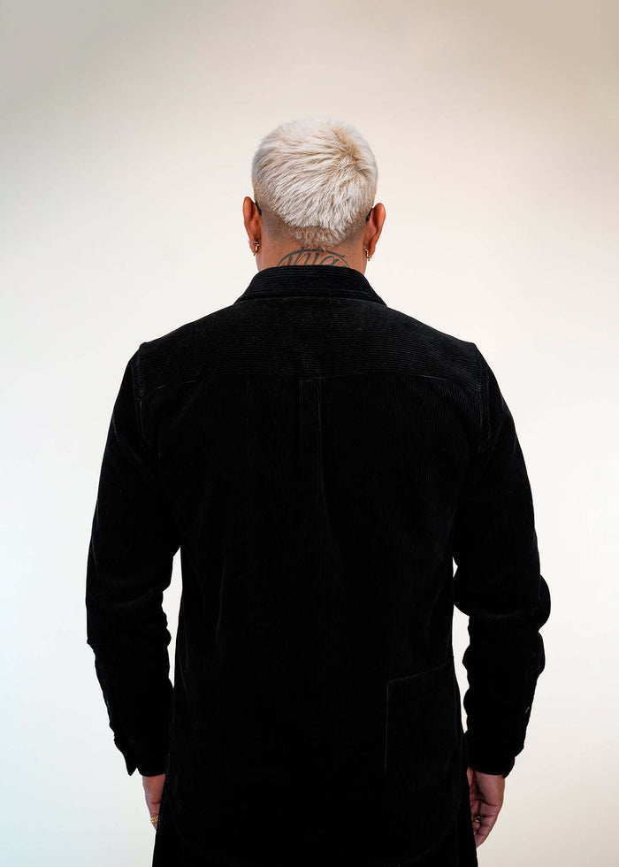 Back view of Éclectique’s corduroy button-up shirt, featuring a relaxed fit and clean silhouette with fine corduroy texture.