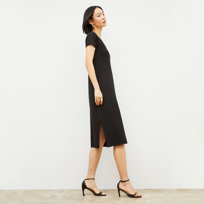 Side image of a woman wearing the Danica Dress - Geo Micro Knit in Black