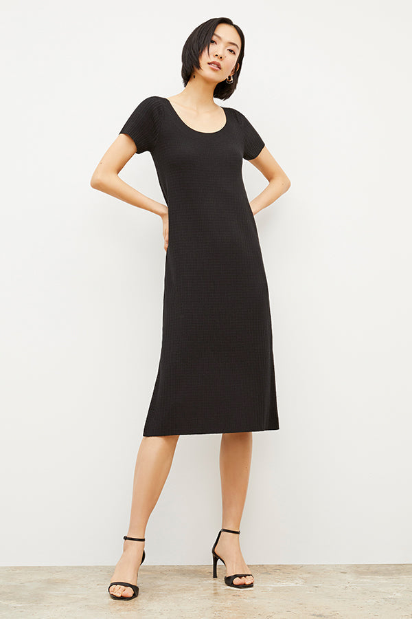 Front image of a woman wearing the Danica Dress - Geo Micro Knit in Black | Grid | Exclude