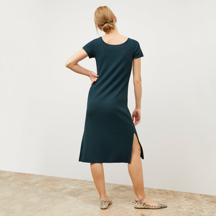 Back image of a woman wearing the Danica Dress - Geo Micro Knit in Deep Sea