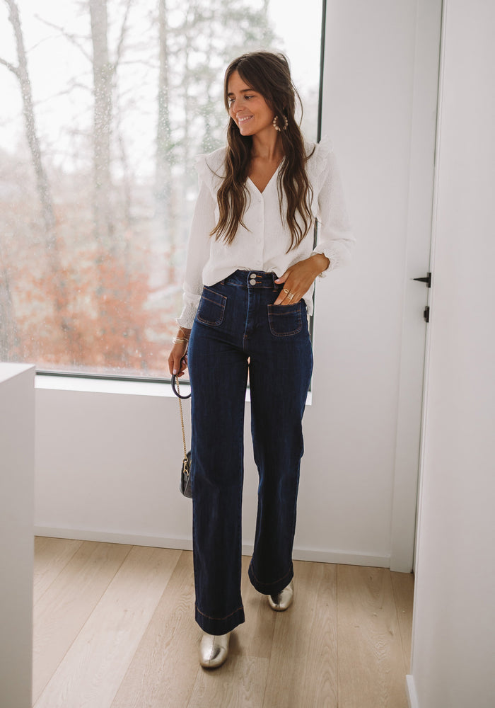 Dark blue Hugues high-rise flare denim styled outfit