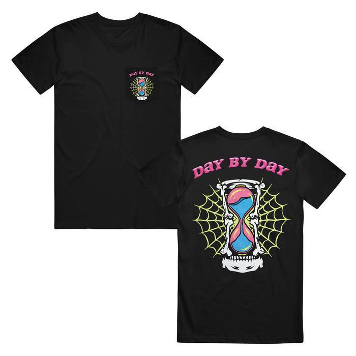 A Foreign Affair Day By Day black pocket t-shirt. the pocket of the shirt has a hourglass with a spiderweb behind it and the text Day By Day in pink above the hourglass. the back of the shirt has the same print covering the whole back.
