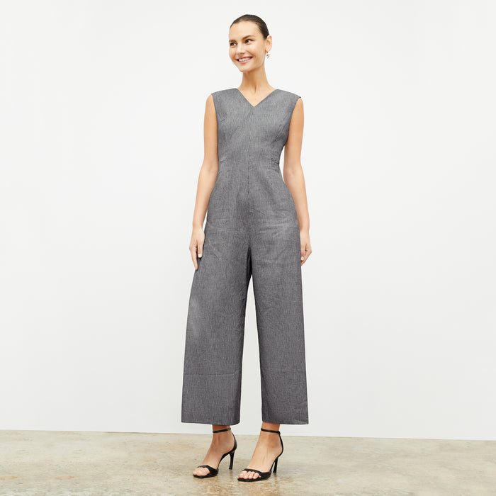front image of a woman wearing the demi jumpsuit in gingham linen