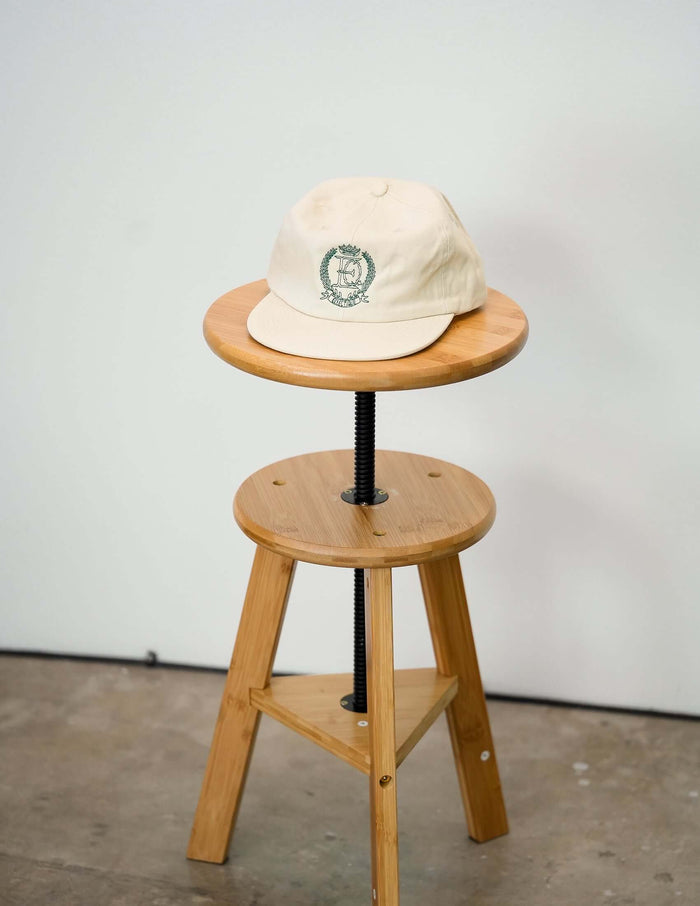 Éclectique crest embroidered dad hat with embroidered crest logo in studio setting
