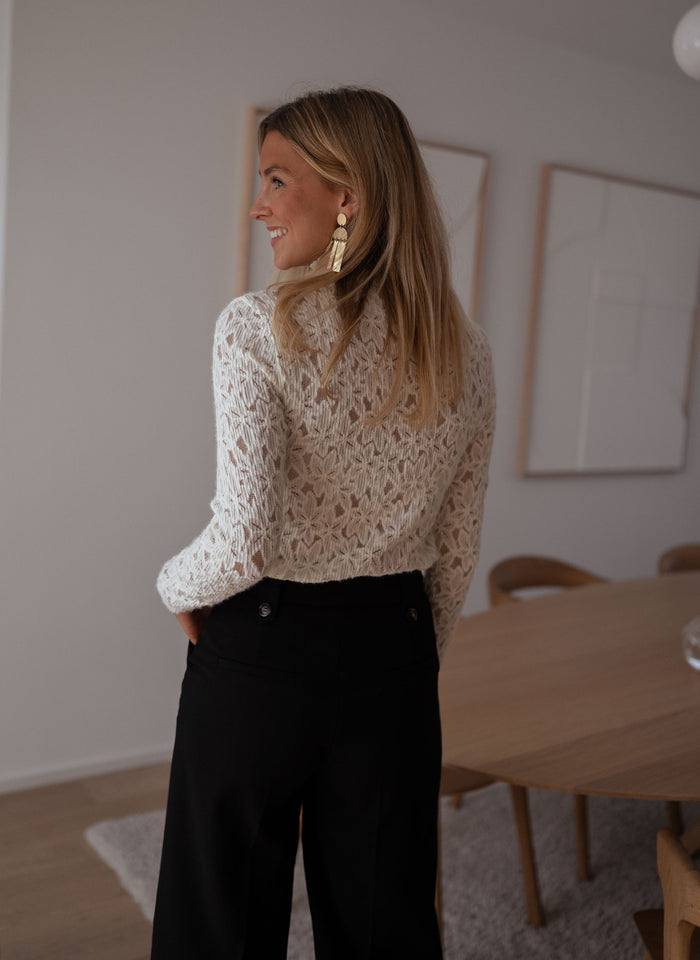 Model wearing ecru Anais lace turtleneck blouse