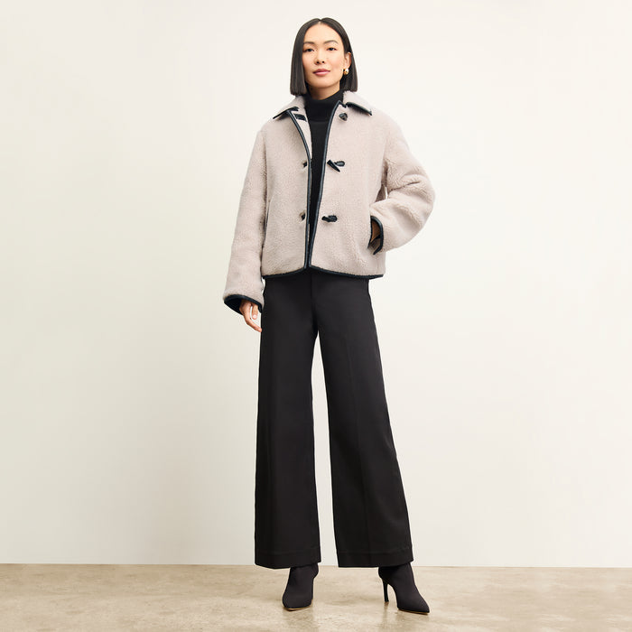 Front image of a woman wearing the eli jacket in travertine