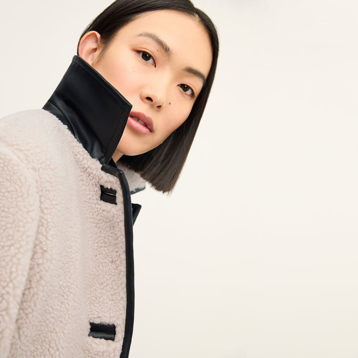 Front image of a woman wearing the eli jacket in travertine