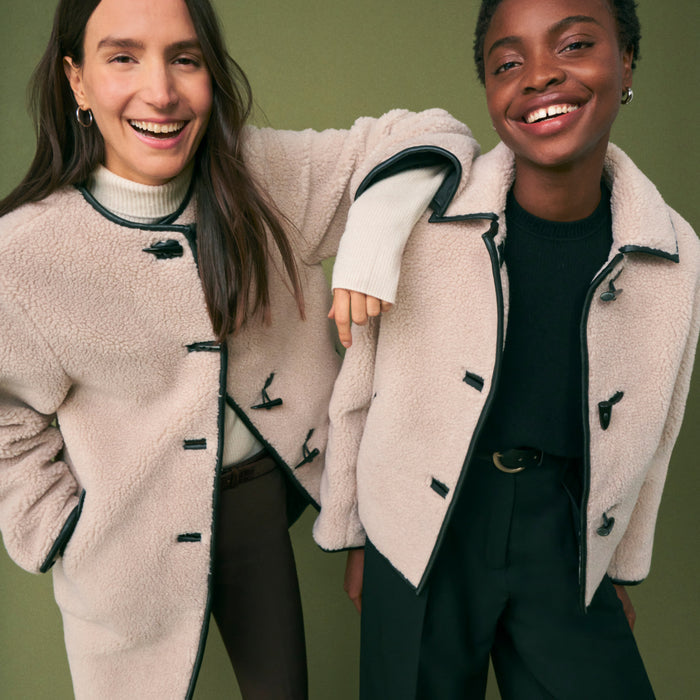 front image of two women wearing the eli jacket and katari coat