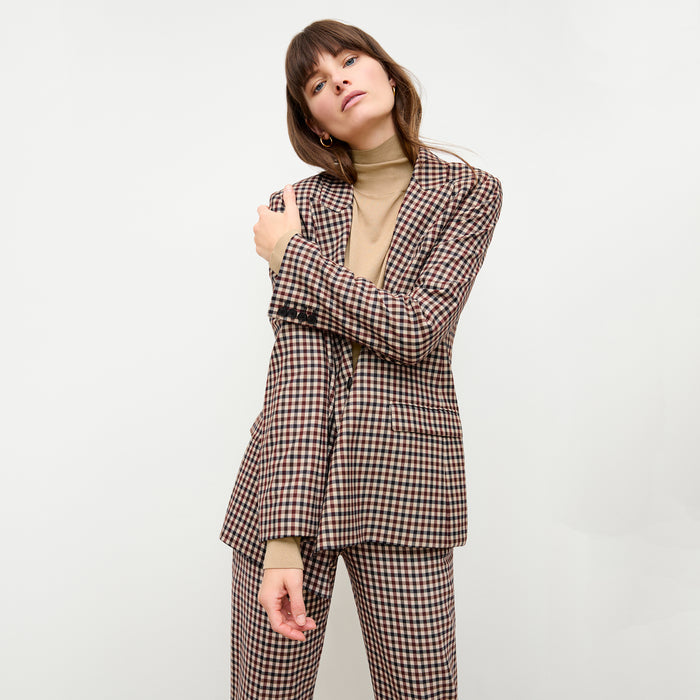 front image of a woman wearing the elizabeth turtleneck in camel