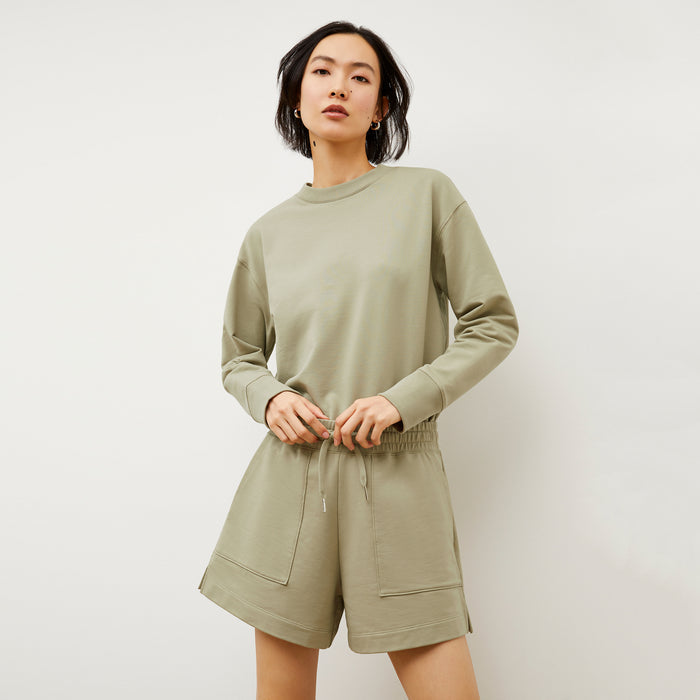 Front image of a woman wearing the Ellie Pullover - Light French Terry in Laurel Green